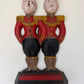 Antique Hubley cast iron doorstop featuring two Anne Fish-designed footmen in matching red coats and gold braid, front view